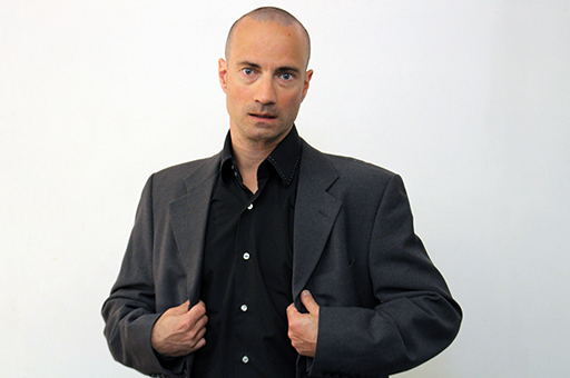 Portrait of Patrick Forian - in black shirt an suit